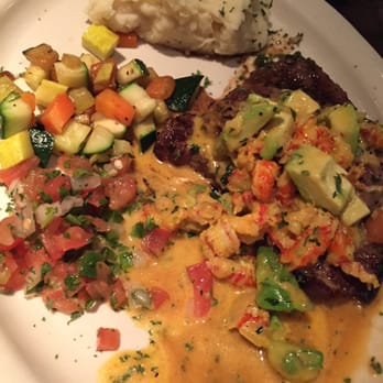 Fernando's - Steak with crawfish and avocado salad topping served with mashed potatoes and seasonal veggies - Steakhouses Near Me - Sugar Land, Texas