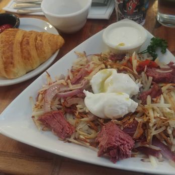 Petite Provence - Corned beef hash with poached eggs and a crossaint with raspberry jelly. - Bakeries Near Me - The Dalles, Oregon Petite Provence - Corned beef hash with poached eggs and a crossaint with raspberry jelly. - Bakeries Near Me - The Dalles, Oregon