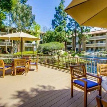 The Plaza Condominiums - Tables and shade umbrellas near the pond. Two gas grills are located nearby. - Condominiums Near Me - San Diego, California The Plaza Condominiums - Tables and shade umbrellas near the pond. Two gas grills are located nearby. - Condominiums Near Me - San Diego, California
