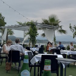 Ristorante Francesco - OUTSIDE DINING CAPTURES LAKE GARDA BREEZES A FEW STEPS AWAY.