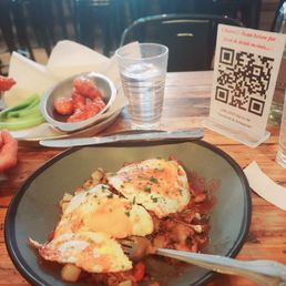Background: boneless chicken tenders Foreground: BBQ hash with eggs Background: boneless chicken tenders Foreground: BBQ hash with eggs