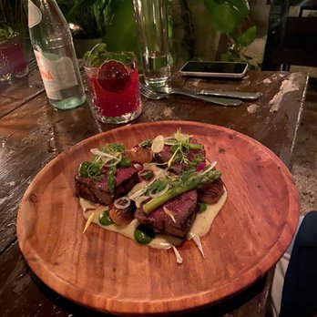 WILD - Wagyu New York Strip, truffle pommes purée, asparagus tips, chimichurri, hassleback potatoes, bordelaise sauce - Cocktail Bars Near Me - Tulum, ROO