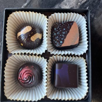 Monsoon Chocolate Cafe + Market - Clockwise from top left: Almond Apricot Caramel, Mesquite White Chocolate, Blackberry Pate de Fruit, Pomegranate Hibiscus Carmel - Chocolatiers & Shops Near Me - Tucson, Arizona