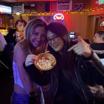 Lenora's Bar & Grill - two women eating pizza - Bars Near Me - Hackensack, New Jersey