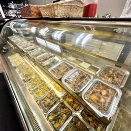 a variety of food in a display case