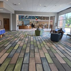 North Cobb Regional Library - Open foyer concept. Portraits on wall, community events on tables.