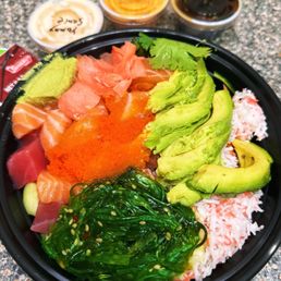 Poke fun bowl, toppings and sauces on the side
