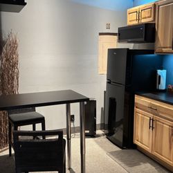 Montano's Granite - This is what the space looked like before generic IKEA countertop on top of the cabinet and floating table with two stainless legs.