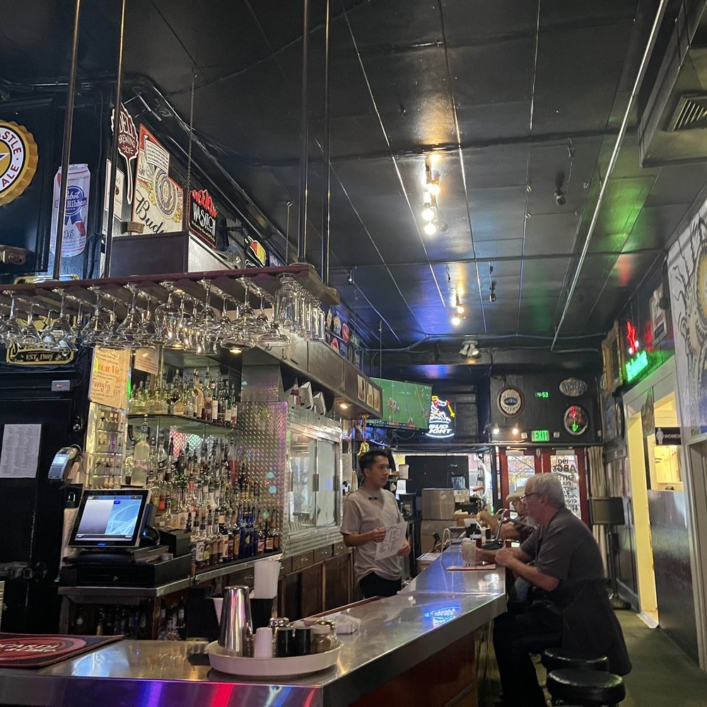 two men sitting at a bar