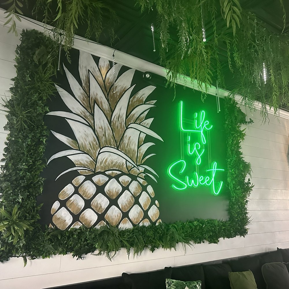 a neon sign with a pineapple on it a neon sign with a pineapple on it