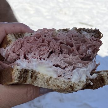 Scott's Deli - a person holding a sandwich - Delis Near Me - Holmes Beach, Florida