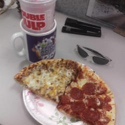 7-Eleven - Split with a couple co-workers, 2 pizzas for $10 is very inexpensive.
Not the best pizza, but definitely worth the price.