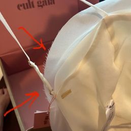 Frayed edges on a brand new $716 wedding top (tax included) that Cult Gaia falsely claimed was "exactly as advertised." Frayed edges on a brand new $716 wedding top (tax included) that Cult Gaia falsely claimed was "exactly as advertised."