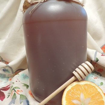 Paul's Bees - a jug of honey and an orange - Honey Near Me Paul's Bees - a jug of honey and an orange - Honey Near Me