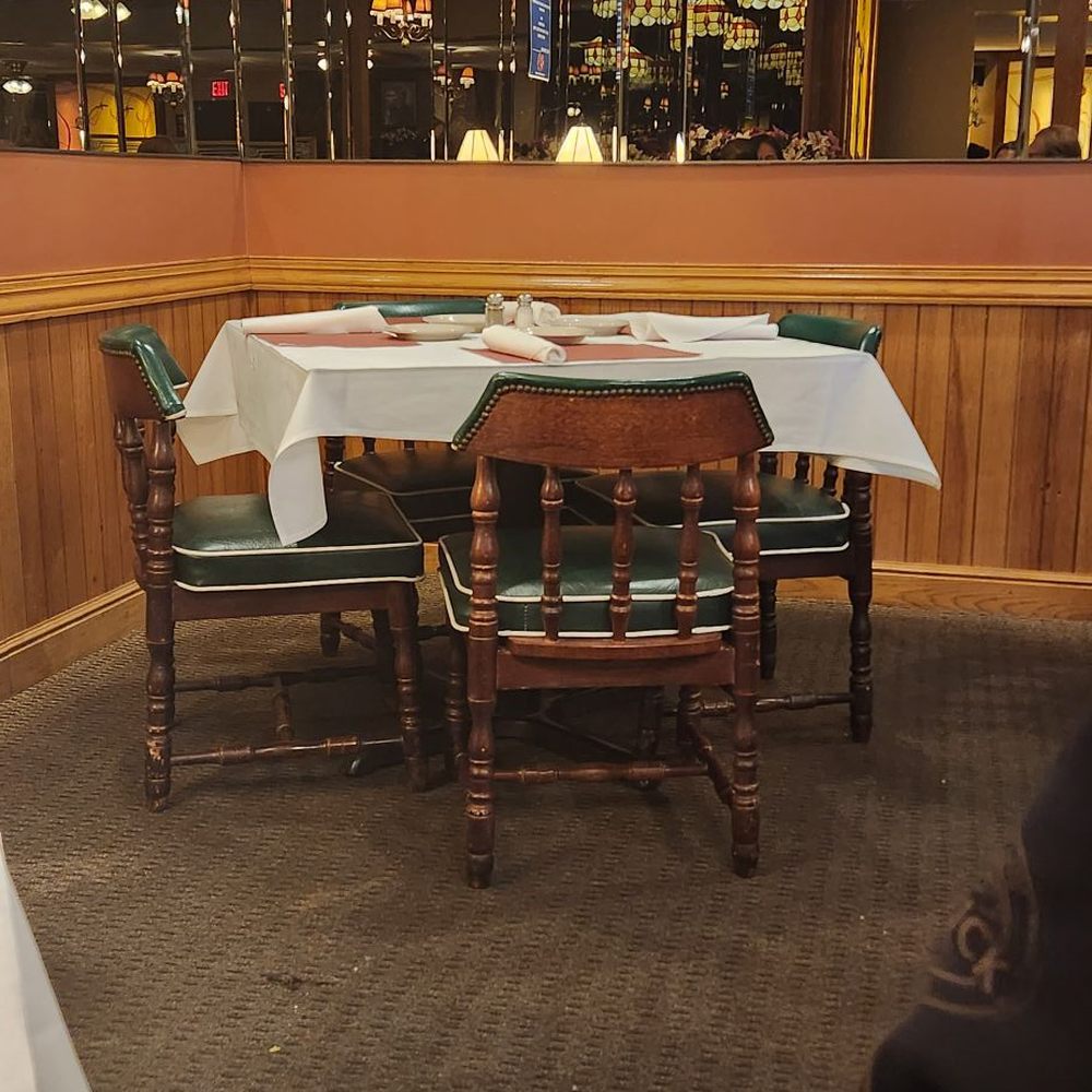 a table and chairs in a restaurant a table and chairs in a restaurant