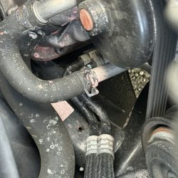 ARCO - Before: Pink-ish splashes of droplets were coolant. Leak was minor, as coolant level on reservoir was still ok.