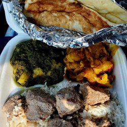 Mazedaar Authentic Indian Cusine - Lamb, aloo palak (potato and cabbage) and spinach with potatoes with naan.