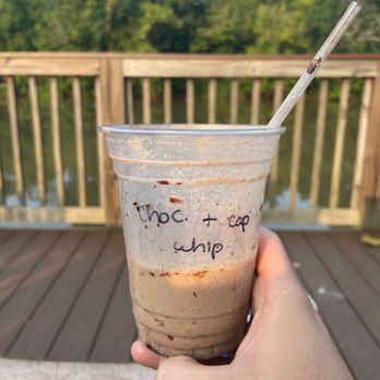 Floyd & Blackie's - a hand holding a cup of coffee - Coffee & Tea Near Me - Cramerton, North Carolina