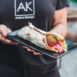 Anita's Kitchen - Falafel sandwich with pickled turnips, lettuce, tomato, and tahini sauce.