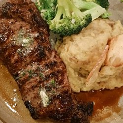 Finch's Restaurant and Lounge - 12 oz NY strip topped w/ garlic butter; garlic mashed potatoes w/ caramelized onions; steamed broccoli with minced garlic.