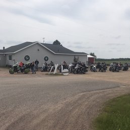 a group of motorcycles parked in front of a building a group of motorcycles parked in front of a building