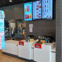 The order counter and menu board are clean snd orderly.
