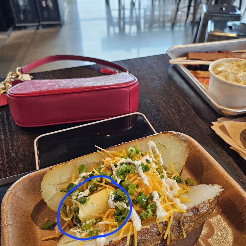 Baked potato with large chunk of unmelted cold butter Baked potato with large chunk of unmelted cold butter