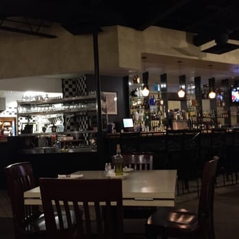 Ruggero's - a man standing at a bar - Pizza Near Me - Flint, Michigan