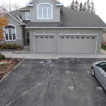 Yard Kings - a car parked in front of a house - Landscaping Near Me