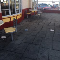 Trash on the ground in the play area.