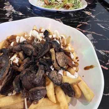 Phatties - Mole fries topped with mushroom and the other dish is the potato tacos - Mexican Near Me - Escondido, California Phatties - Mole fries topped with mushroom and the other dish is the potato tacos - Mexican Near Me - Escondido, California