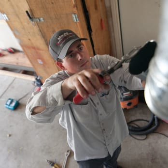 Moore Home Services - One of our installers modifying a flue to connect up to a new furnace. - Heating & Air Conditioning/HVAC Near Me - Santa Rosa, California Moore Home Services - One of our installers modifying a flue to connect up to a new furnace. - Heating & Air Conditioning/HVAC Near Me - Santa Rosa, California