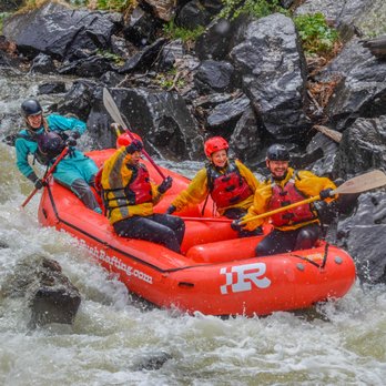 River Rush Rafting - Three paddlers cheer and laugh after successfully navigating a Class IV rapid on Clear Creek. - Rafting/Kayaking Near Me - Idaho Springs, Colorado River Rush Rafting - Three paddlers cheer and laugh after successfully navigating a Class IV rapid on Clear Creek. - Rafting/Kayaking Near Me - Idaho Springs, Colorado