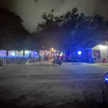 The Red Door Saloon - a car parked in a parking lot - Dive Bars Near Me - Destin, Florida