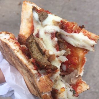 Sergio's Pizza - Halfway through a delicious Meat Lovers slice from Sergio's Pizza in Malcolm X Blvd, Bedford Stuyvesant - Pizza Near Me - Brooklyn, New York Sergio's Pizza - Halfway through a delicious Meat Lovers slice from Sergio's Pizza in Malcolm X Blvd, Bedford Stuyvesant - Pizza Near Me - Brooklyn, New York