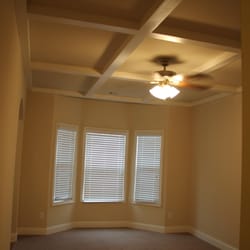 Premier Realty & Property Management Services - This beautiful livingroom has deep cauffer ceilings! Call today to see the other amazing features this home offers.