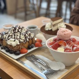 a bowl of ice cream, a bowl of strawberries, and a bowl of strawberries