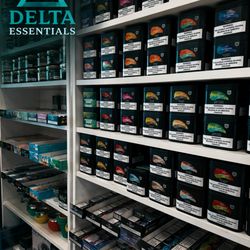 Delta Smoke Shop - Clean, well-stocked shelves with premium products, organized neatly under bright lighting, showcasing a wide selection in a retail selection