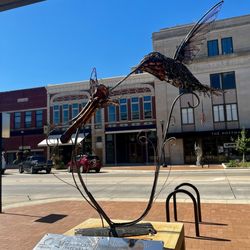 Red Fern Booksellers - Looking through the statue across the street at the storefront