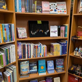 The Enchanted Attic - Wooden bookshelves filled with books, jewelry, and decorative items in a retail store setting. - Jewelry Near Me - Saint Charles, Missouri