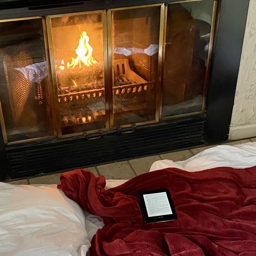 Cozied up to the fireplace with a book on a rainy day. Cozied up to the fireplace with a book on a rainy day.