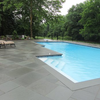 Creative Design Landscapes - A serene poolscape framed by a beautifully crafted pergola, where clean lines and natural textures come together to create a private oasis. - Landscaping Near Me - East Hampton, New York Creative Design Landscapes - A serene poolscape framed by a beautifully crafted pergola, where clean lines and natural textures come together to create a private oasis. - Landscaping Near Me - East Hampton, New York
