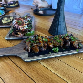 The Crouching Lion - BBQ chicken, whole grilled squid, grilled trumpet mushrooms, hamachi kama (yellowtail collar). - Beer Bar Near Me - Kaaawa, Hawaii The Crouching Lion - BBQ chicken, whole grilled squid, grilled trumpet mushrooms, hamachi kama (yellowtail collar). - Beer Bar Near Me - Kaaawa, Hawaii