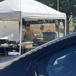 Prepping for the lunch rush under the pop up tent in the convenience store parking lot.