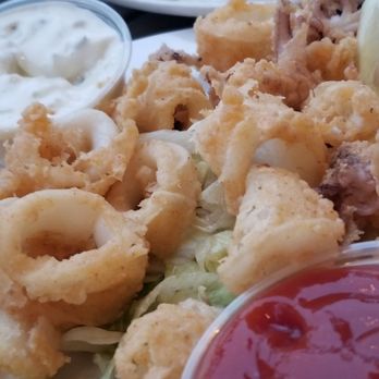 London Bridge Pub - Calamari,  small tender pieces, light batter, fried to perfection w creamy real homemade tartar sauce & fresh lemon wedges - British Near Me - Monterey, California