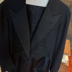 Toni Cleaners - A handsome black tailcoat on a hanger, ready to walk a red carpet.