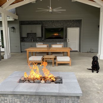 Fulster Construction - a dog sitting in front of a fire pit - General Contractors Near Me - Sacramento, California