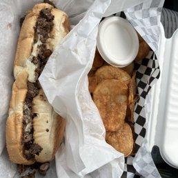 Cheesesteak with chips.