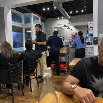 Dodici Pizza & Wine - a man using a calculator - Pizza Near Me - Brownsville, Texas Dodici Pizza & Wine - a man using a calculator - Pizza Near Me - Brownsville, Texas