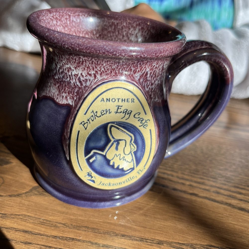 Another Broken Egg Cafe - a purple coffee cup with a purple handle - Breakfast & Brunch Near Me - Jacksonville, Florida Another Broken Egg Cafe - a purple coffee cup with a purple handle - Breakfast & Brunch Near Me - Jacksonville, Florida